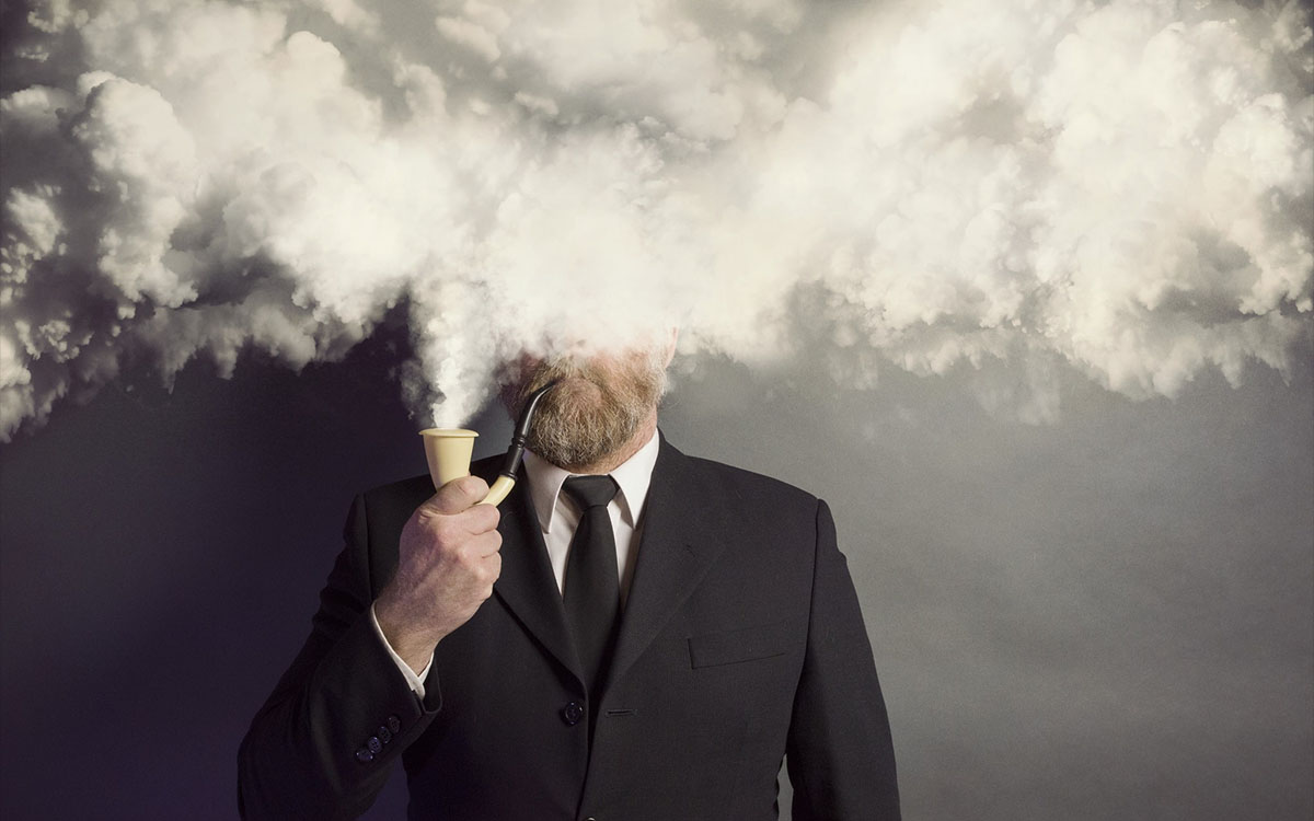 man in suit covered by smoke