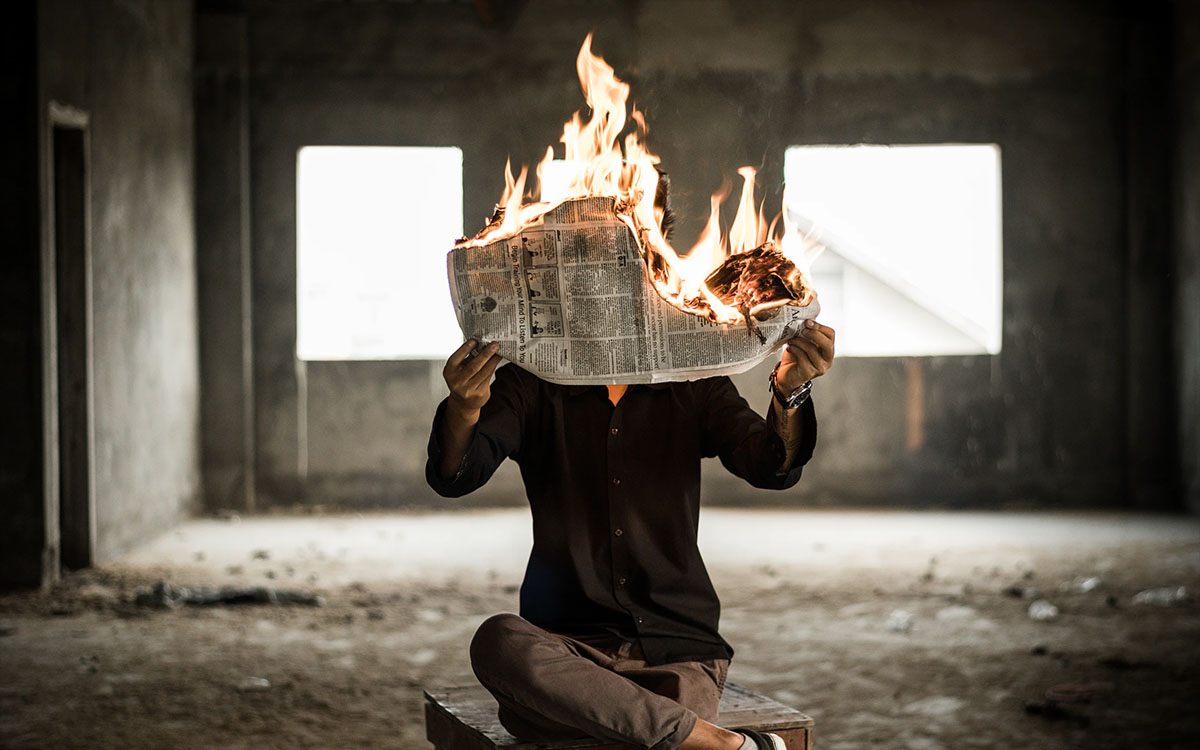 reading news on fire abandoned building