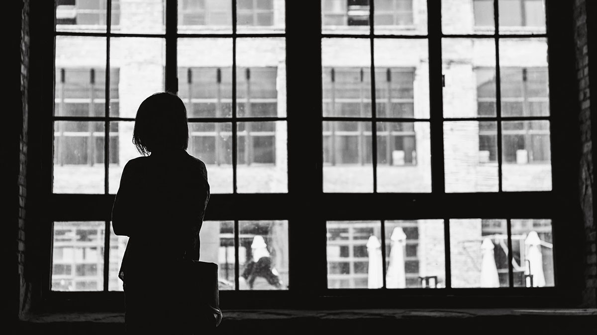 woman looking out window