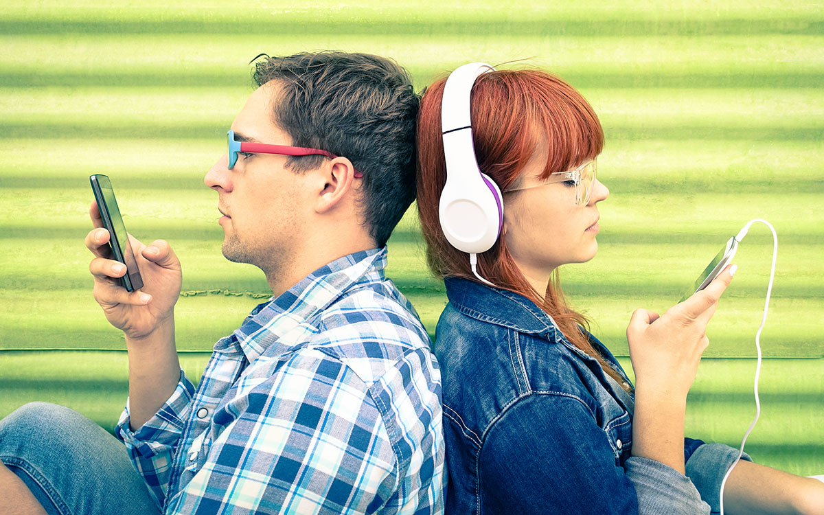 young couple buried in phones